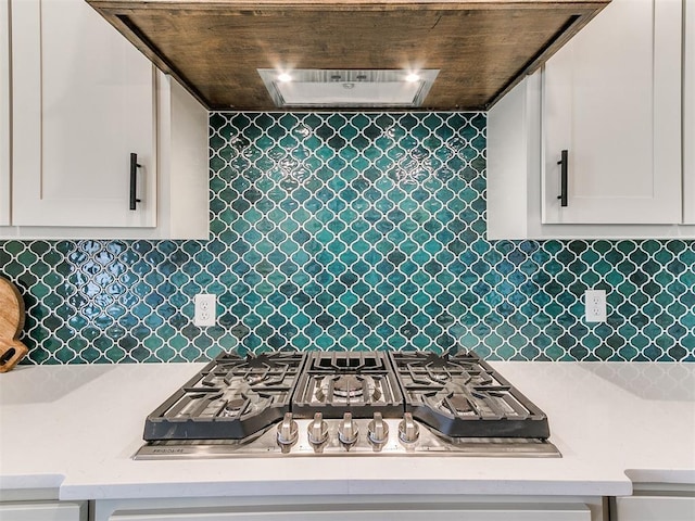 9316 NW 84th St, Yukon, OK 73099 - kitchen featuring stainless steel gas stovetop, white cabinetry, light stone countertops, tasteful backsplash, and wood ceiling