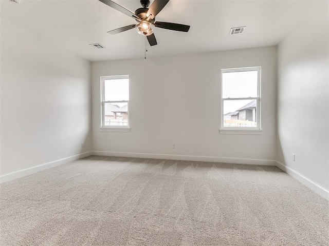 9316 NW 84th St, Yukon, OK 73099 - empty room featuring a ceiling fan, light carpet, and baseboards