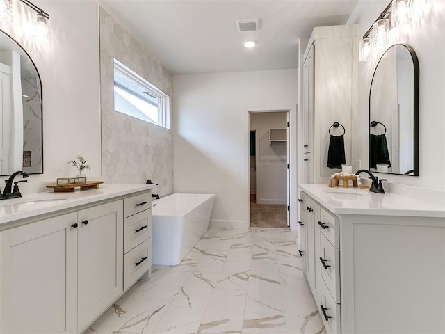 9316 NW 84th St, Yukon, OK 73099 - full bath with two vanities, a freestanding bath, recessed lighting, marble finish floors, and baseboards