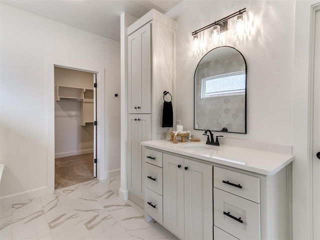 9316 NW 84th St, Yukon, OK 73099 - full bathroom featuring vanity, a spacious closet, marble look tile flooring, and baseboards