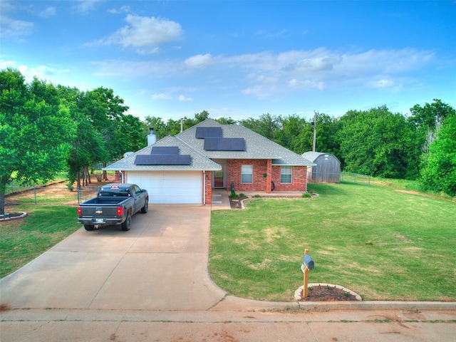 409 NW Jefferson Ave, Piedmont, OK 73078 - view of front facade with brick siding, concrete driveway, solar panels, an attached garage, and a shingled roof