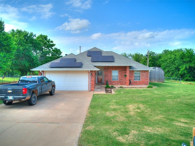 409 NW Jefferson Ave, Piedmont, OK 73078 - view of front of home featuring roof with shingles, driveway, brick siding, a garage, and roof mounted solar panels