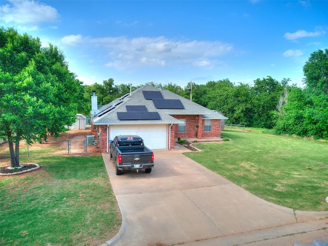 409 NW Jefferson Ave, Piedmont, OK 73078 - view of front of house featuring brick siding, concrete driveway, roof mounted solar panels, a gate, and an attached garage