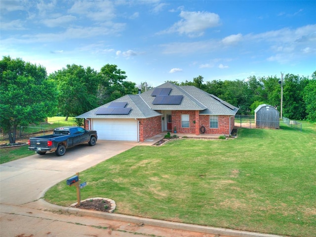 409 NW Jefferson Ave, Piedmont, OK 73078 - view of front of property featuring brick siding, concrete driveway, a garage, roof with shingles, and roof mounted solar panels
