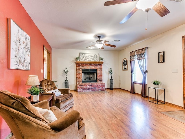 409 NW Jefferson Ave, Piedmont, OK 73078 - living area featuring a ceiling fan, light wood-style flooring, a fireplace, and baseboards