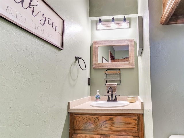 409 NW Jefferson Ave, Piedmont, OK 73078 - bathroom with vanity, a textured wall, and toilet