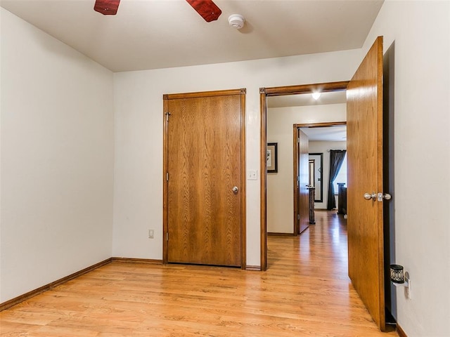 409 NW Jefferson Ave, Piedmont, OK 73078 - unfurnished bedroom with light wood-type flooring, baseboards, and ceiling fan