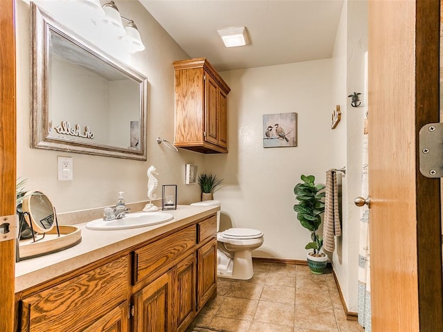 409 NW Jefferson Ave, Piedmont, OK 73078 - bathroom with vanity, toilet, and baseboards