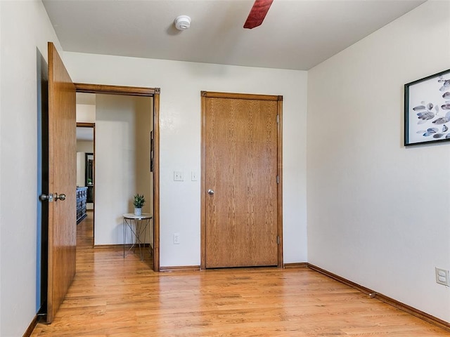 409 NW Jefferson Ave, Piedmont, OK 73078 - unfurnished bedroom featuring light wood finished floors, baseboards, and ceiling fan