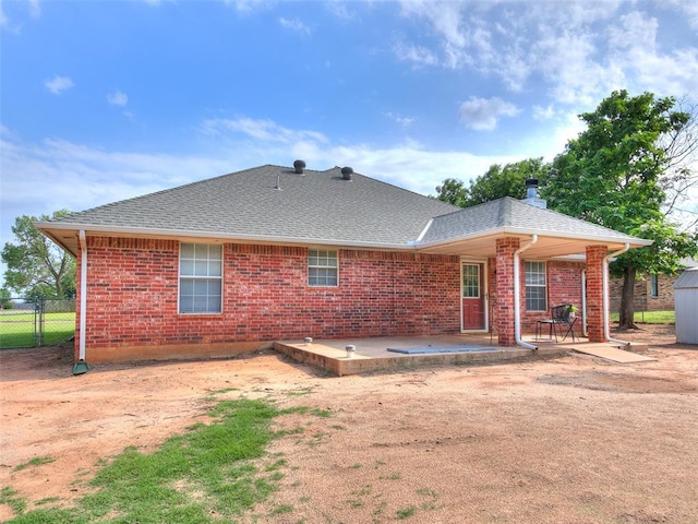 409 NW Jefferson Ave, Piedmont, OK 73078 - back of house with a patio, brick siding, and a shingled roof