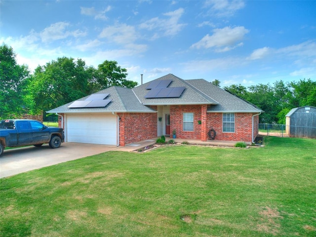 409 NW Jefferson Ave, Piedmont, OK 73078 - view of front of home featuring brick siding, a garage, roof with shingles, roof mounted solar panels, and driveway
