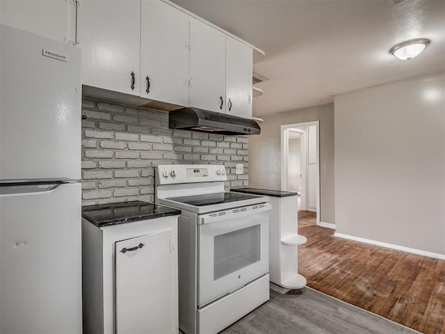 4109 N Sterling Ave, Oklahoma City, OK 73122 - kitchen featuring white appliances, under cabinet range hood, wood finished floors, and white cabinets
