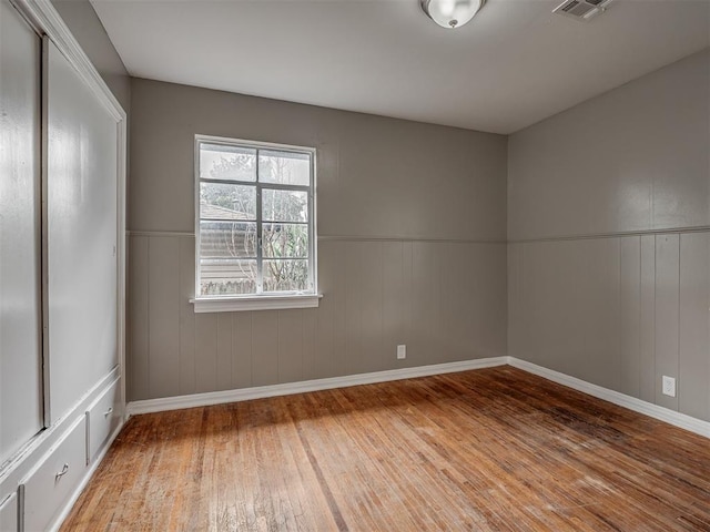 4109 N Sterling Ave, Oklahoma City, OK 73122 - spare room featuring wood finished floors and a wainscoted wall