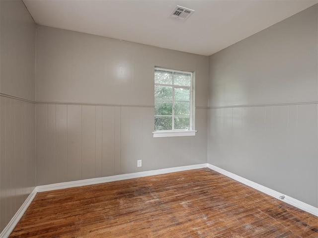 4109 N Sterling Ave, Oklahoma City, OK 73122 - unfurnished room with wood finished floors and a wainscoted wall
