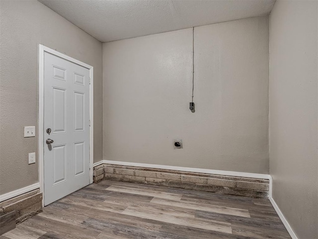 4109 N Sterling Ave, Oklahoma City, OK 73122 - laundry area with hookup for an electric dryer, wood finished floors, and a textured ceiling