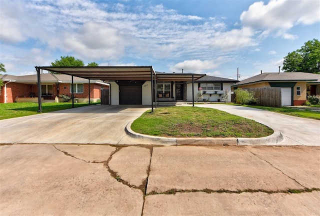 2805 SW 54th Pl, Oklahoma City, OK 73119 - view of front of property with a garage, driveway, a front lawn, brick siding, and an attached carport