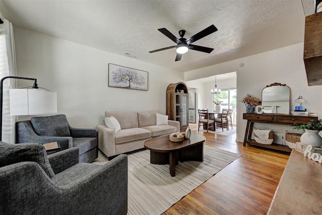 2805 SW 54th Pl, Oklahoma City, OK 73119 - living area featuring light wood-type flooring, ceiling fan, and a textured ceiling