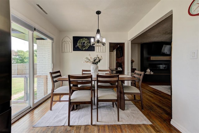 2805 SW 54th Pl, Oklahoma City, OK 73119 - dining space featuring plenty of natural light, wood finished floors, and a chandelier
