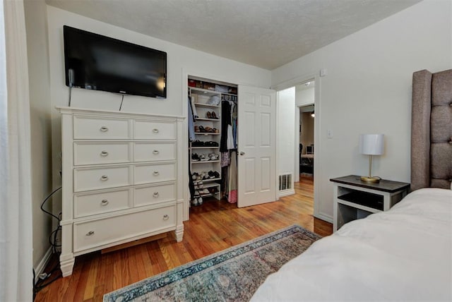 2805 SW 54th Pl, Oklahoma City, OK 73119 - bedroom featuring wood finished floors, a closet, and baseboards
