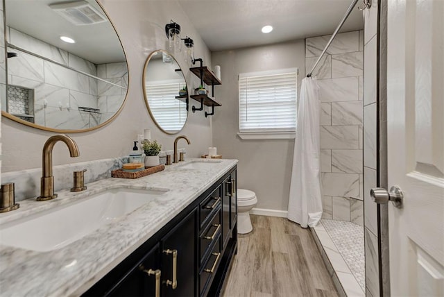 2805 SW 54th Pl, Oklahoma City, OK 73119 - full bathroom with tiled shower, double vanity, toilet, and wood finished floors