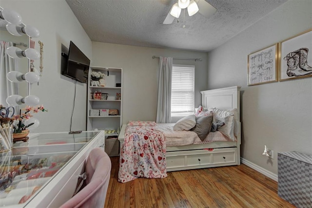 2805 SW 54th Pl, Oklahoma City, OK 73119 - bedroom with a textured ceiling, wood finished floors, ceiling fan, and baseboards