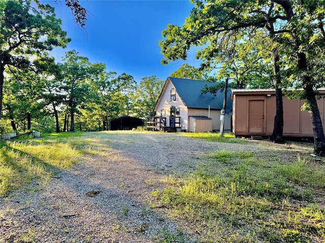 36578 Ns 3500th St, Konawa, OK 74849 - view of side of home with a carport, gravel driveway, and metal roof