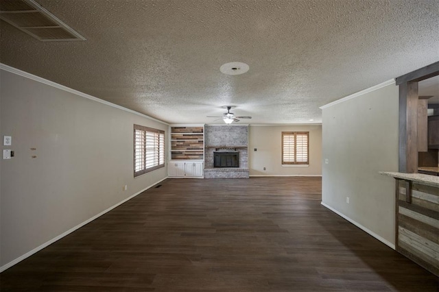 325 S Pine St, Crescent, OK 73028 - unfurnished living room featuring a ceiling fan, crown molding, a fireplace, healthy amount of natural light, and dark wood-style floors