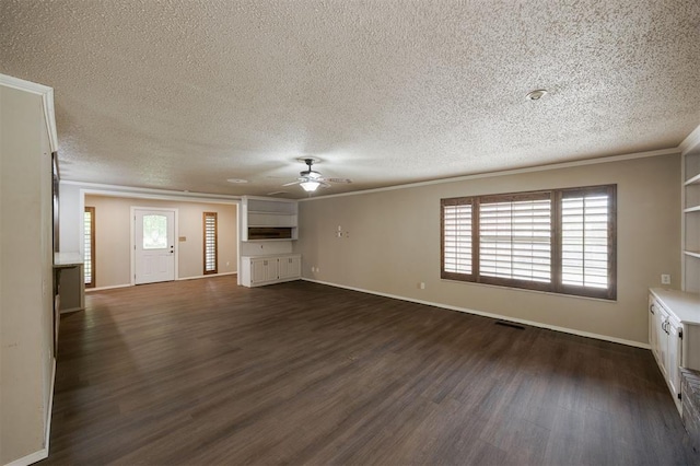 325 S Pine St, Crescent, OK 73028 - unfurnished living room featuring ornamental molding, dark wood-style floors, ceiling fan, a textured ceiling, and baseboards