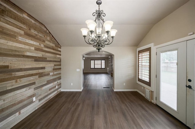 325 S Pine St, Crescent, OK 73028 - unfurnished dining area with arched walkways, wooden walls, vaulted ceiling, a chandelier, and wood finished floors