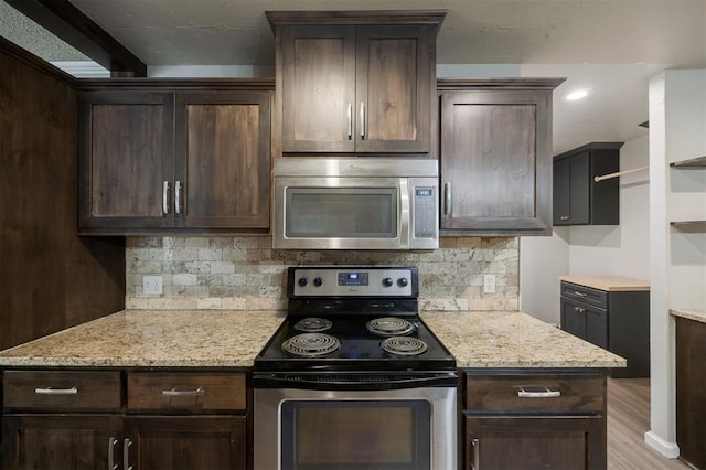 325 S Pine St, Crescent, OK 73028 - kitchen with appliances with stainless steel finishes, dark brown cabinets, and decorative backsplash