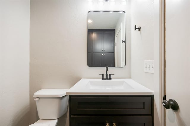 325 S Pine St, Crescent, OK 73028 - bathroom featuring toilet, vanity, and a textured wall