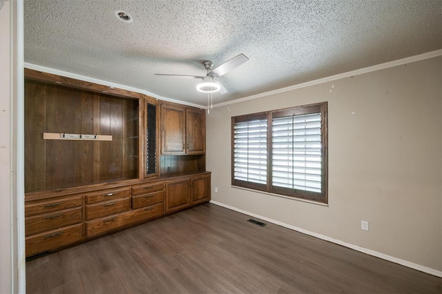 325 S Pine St, Crescent, OK 73028 - unfurnished bedroom with a textured ceiling, dark wood-style floors, baseboards, crown molding, and a ceiling fan