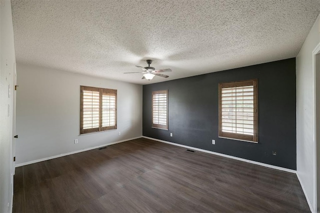 325 S Pine St, Crescent, OK 73028 - empty room with a textured ceiling, a ceiling fan, dark wood-type flooring, and baseboards