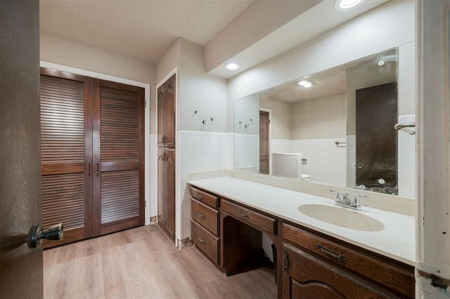 325 S Pine St, Crescent, OK 73028 - bathroom with vanity, wood finished floors, and a wainscoted wall