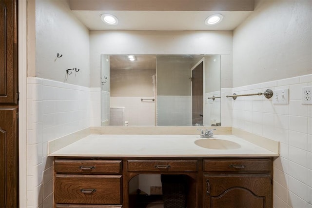 325 S Pine St, Crescent, OK 73028 - bathroom featuring tile walls, vanity, and a wainscoted wall