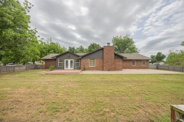 325 S Pine St, Crescent, OK 73028 - back of house featuring french doors, brick siding, a patio, a chimney, and a wooden deck