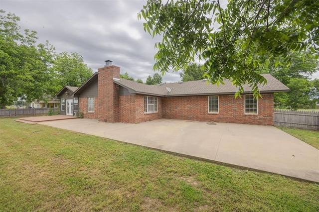 325 S Pine St, Crescent, OK 73028 - back of house with brick siding, a patio, a chimney, and roof with shingles