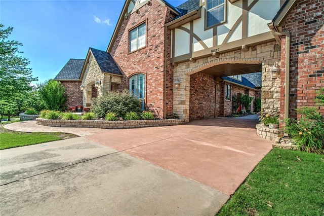 8025 Redbud Canyon Trl, Edmond, OK 73034 - view of property exterior with brick siding, stucco siding, and stone siding