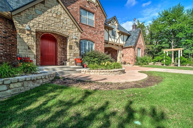 8025 Redbud Canyon Trl, Edmond, OK 73034 - view of front facade with a front yard, brick siding, and stone siding