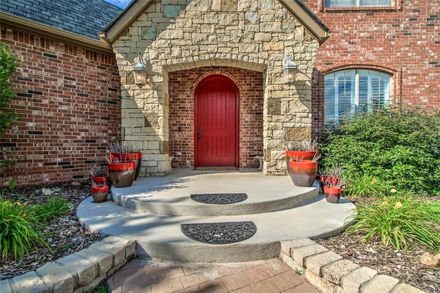 8025 Redbud Canyon Trl, Edmond, OK 73034 - doorway to property featuring stone siding and brick siding