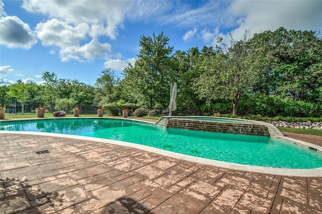 8025 Redbud Canyon Trl, Edmond, OK 73034 - view of swimming pool with view of scattered trees and a pool with connected hot tub