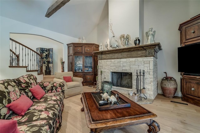 8025 Redbud Canyon Trl, Edmond, OK 73034 - living area with stairway, light wood-style flooring, a fireplace, and vaulted ceiling