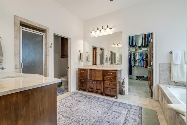 8025 Redbud Canyon Trl, Edmond, OK 73034 - full bath featuring vanity, a garden tub, toilet, a stall shower, and tile patterned floors