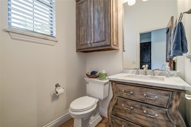 8025 Redbud Canyon Trl, Edmond, OK 73034 - half bathroom with toilet, vanity, and baseboards