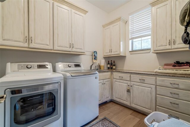 8025 Redbud Canyon Trl, Edmond, OK 73034 - washroom with cabinet space, independent washer and dryer, and light wood-style floors