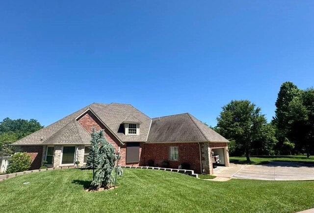 3826 Creek Bank Dr, Edmond, OK 73003 - view of front of property featuring driveway, a front yard, brick siding, and an attached garage