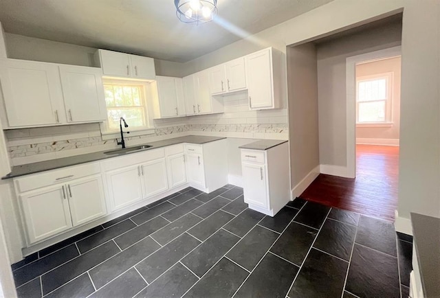 929 NE 17th St, Oklahoma City, OK 73105 - kitchen with a sink, backsplash, healthy amount of natural light, and white cabinetry
