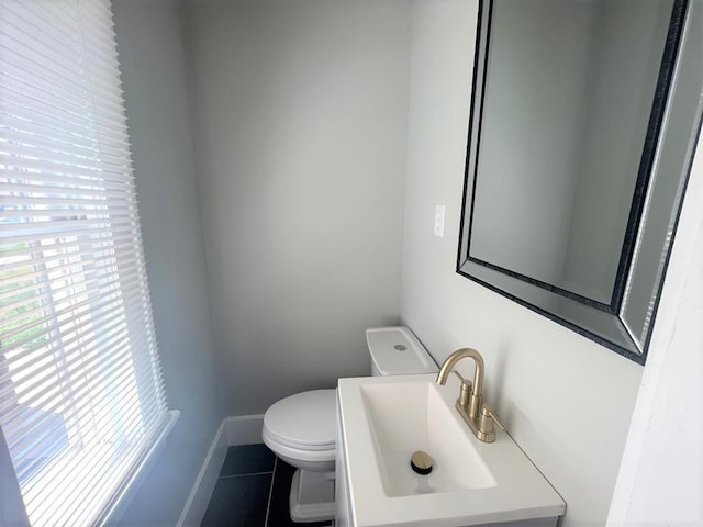 929 NE 17th St, Oklahoma City, OK 73105 - half bath featuring healthy amount of natural light, toilet, tile patterned floors, and baseboards