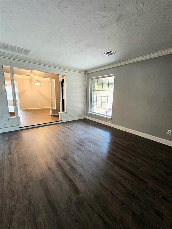 6013 Greenview Dr, Oklahoma City, OK 73135 - unfurnished room with baseboards, wood finished floors, and a textured ceiling