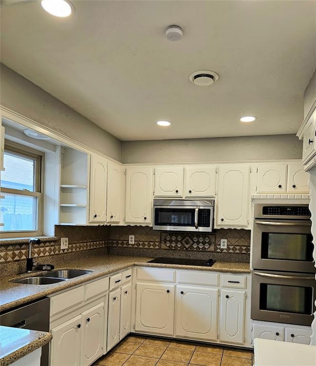 6013 Greenview Dr, Oklahoma City, OK 73135 - kitchen with a sink, appliances with stainless steel finishes, white cabinetry, light tile patterned flooring, and tasteful backsplash